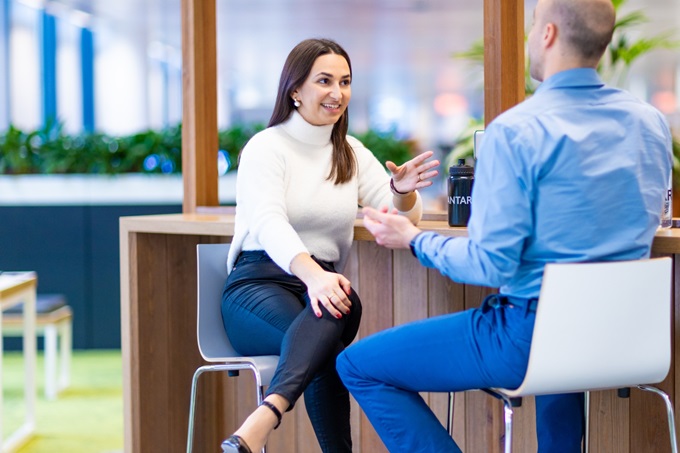 Colleagues talking at a high bench