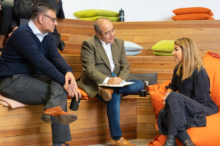 A group of three colleagues chatting together