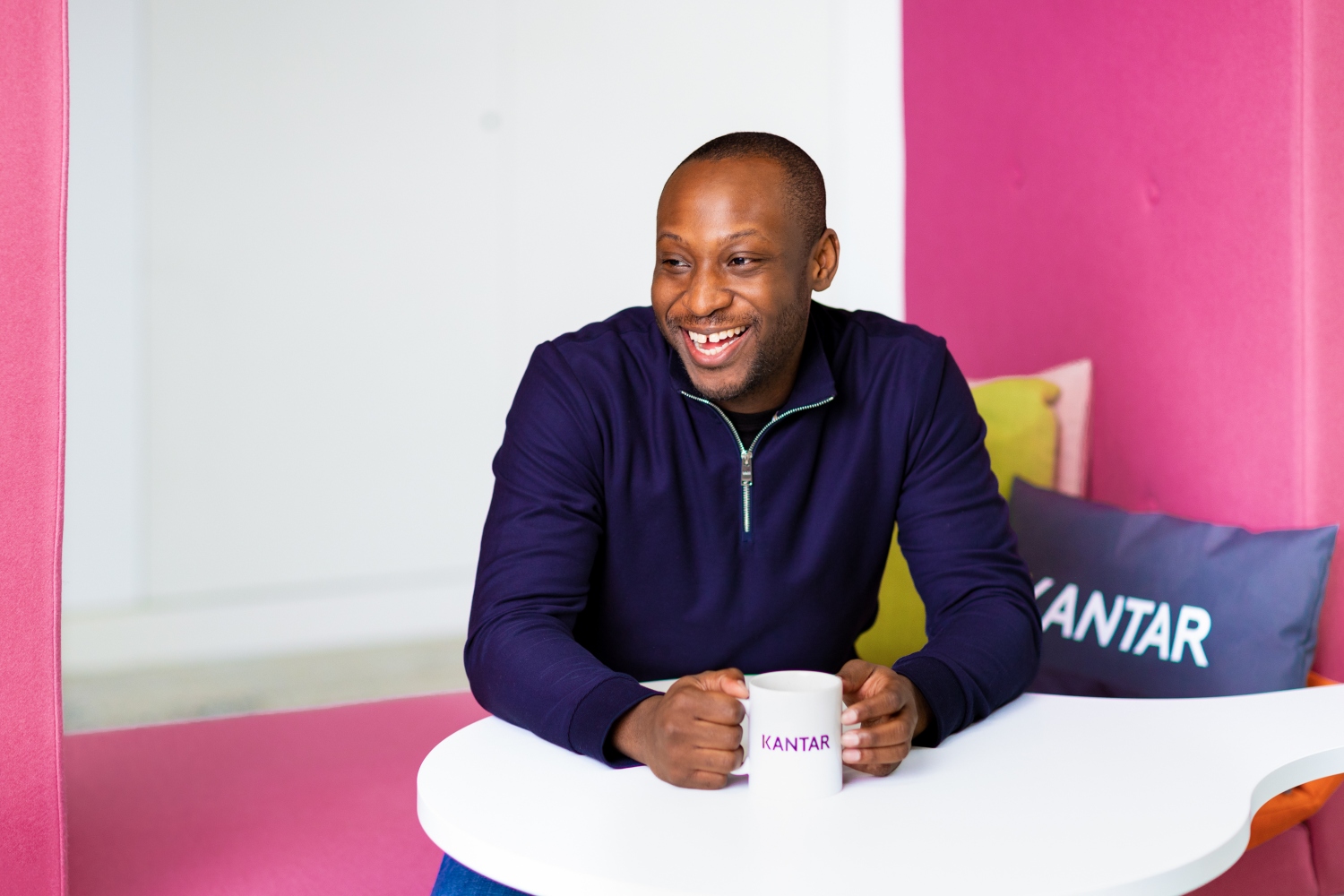 A man sitting a desk with a mug