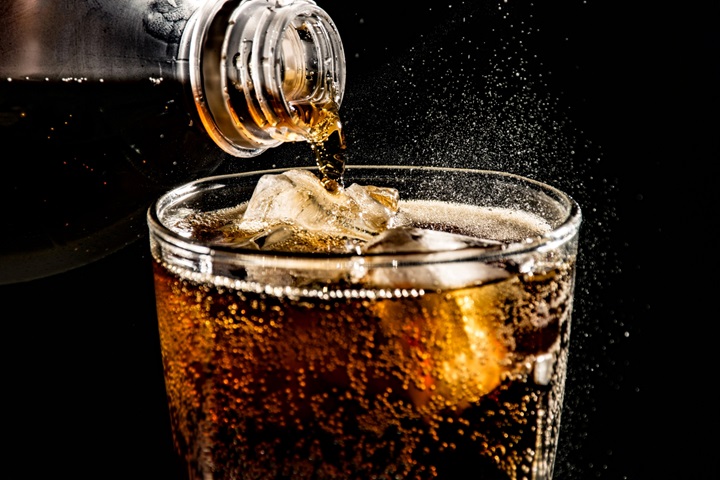 close up of drink pouring in drinking glass